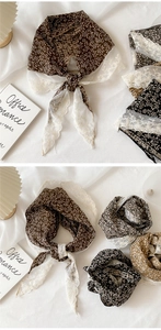 Detail of floral cotton linen triangular scarf with hollow crochet lace edging