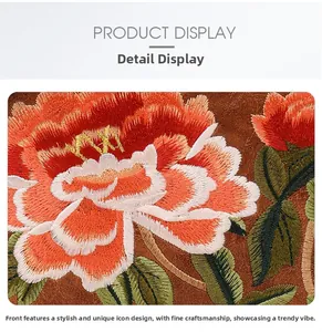 Close-up of vibrant floral embroidery details on brown suede fabric with fine stitching