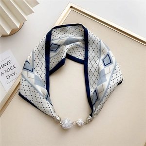 Detail of navy blue silk scarf with geometric pattern and crystal magnetic metal buckle