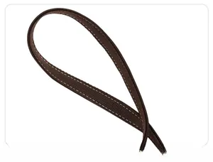 Close-up of thick dark brown shoulder strap with white stitching and twill texture