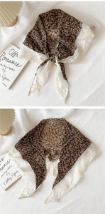 Detail of vintage brown floral cotton scarf with intricate white lace embroidery trim
