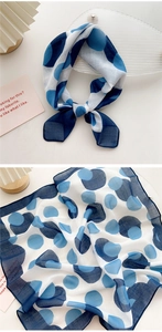 Detailed view of polka dot cotton linen scarf showing fabric texture and navy blue patterns