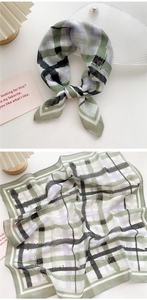 Detail view of plaid cotton linen small square scarf with green and purple checkered pattern