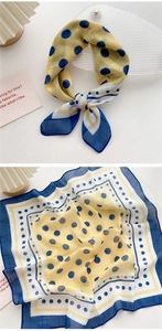 Detail of yellow cotton linen scarf with navy blue polka dots and delicate stitched edges