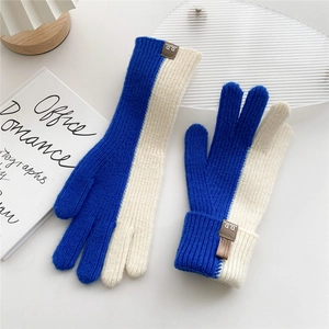Detail of navy and beige knit gloves with dual-tone design and brown leather D.D tag