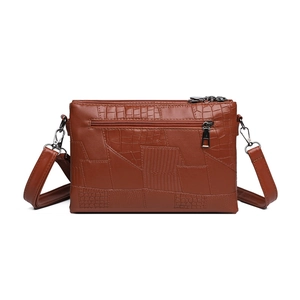 Brown faux leather crossbody bag with crocodile texture and adjustable shoulder strap