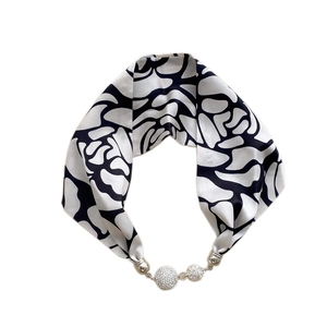 Silk scarf with black and white abstract pattern and sparkling rhinestone magnetic buckle
