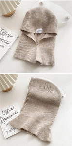 Detail of oatmeal knit balaclava showing ribbed texture and hood design for winter