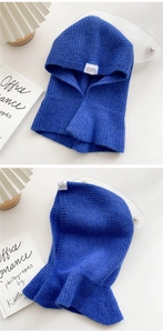 Detail of royal blue knitted balaclava hood scarf with vertical ribbed texture and tag