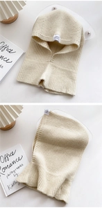 Detailed knit texture and label of a beige balaclava hood scarf with vertical ribbing