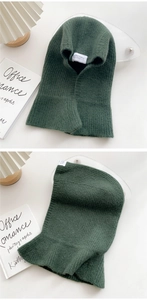 Detailed view of dark green knitted balaclava hood scarf with ribbed texture and white label