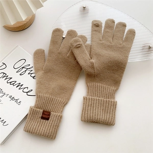 Detailed view of camel knit gloves with ribbed cuffs and special touch screen fingertips