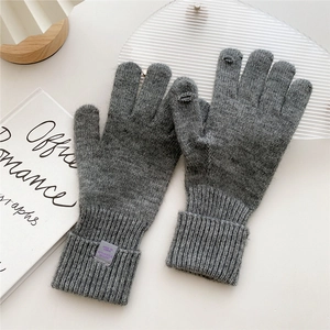 Detail of dark grey knit gloves with open finger design for touchscreen compatibility