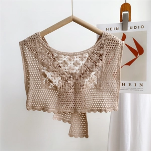 Macro detail of beige crochet lace floral hollow pattern with delicate ties