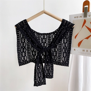 Close-up of black lace hollow-out shawl collar with geometric weave and tie-up design