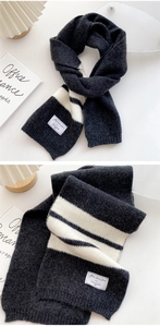Close-up of thick striped knit scarf with soft fabric texture and vintage woven label detail