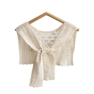 Beige crochet lace shawl featuring intricate floral hollow-out patterns and tie-front closure