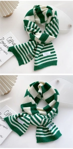 Detailed macro of green and white striped knit scarf showing textured ribbed finish