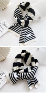 Detail of soft striped knit scarf showing textured wool blend fabric and brand tag