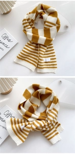 Close-up of ginger and white striped knit scarf with thick warm texture and soft fringe
