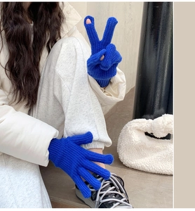 Detail of royal blue knit gloves with finger opening for touchscreen use in winter