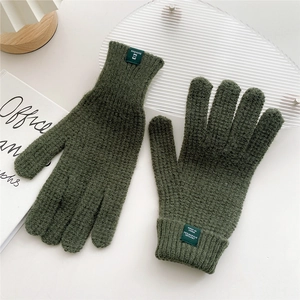 Close-up of olive green knit gloves showing 70% acrylic material tag and texture