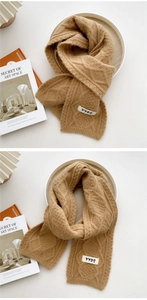 Detail of camel cable knit scarf showing thick texture and YYDS decorative fabric label