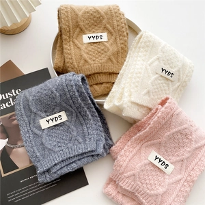 Chunky cable knit scarves in neutral colors featuring a stylish YYDS woven label detail