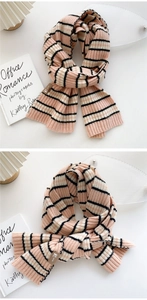 Detail of soft knit pink and white striped scarf with a premium faux leather brand label