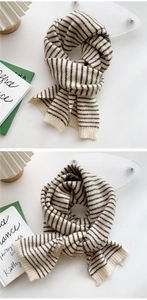 Close-up of striped knit scarf texture featuring premium rib knit and brand detail label
