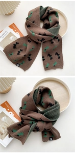 Nahaufnahme eines dicken Strickschals mit braunem Terrier-Muster und weicher Textur