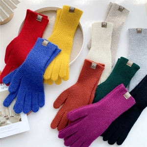 Colorful knitted winter gloves for women and men in various vibrant solid color shades