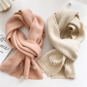 Classic knitted warm scarf for women and men in soft pastel pink and beige colors