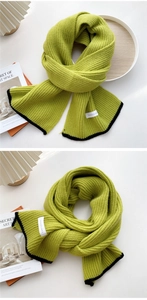Detailed view of lime green rib-knit scarf with black borders and premium texture