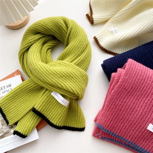 Thick knitted scarves in various colors with vertical stripes and contrast borders
