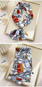 Detail of silk scarf with vintage crown and chain pattern on 100% polyester fabric
