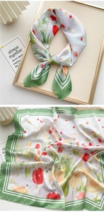 Close-up of elegant square silk scarf with green stripes and floral tulip pattern