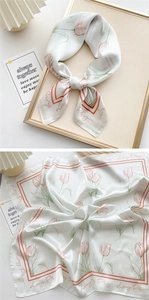 Detail of tulip printed silk scarf showing tied style and flat floral pattern layout