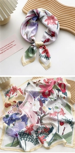 Detailed close-up of floral silk scarf with vibrant orchid patterns and satin texture