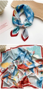 Close-up of a blue and red artistic graffiti print silk scarf with knotted styling