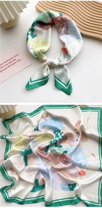 Detail of 70cm silk scarf featuring colorful cartoon illustrations and green borders