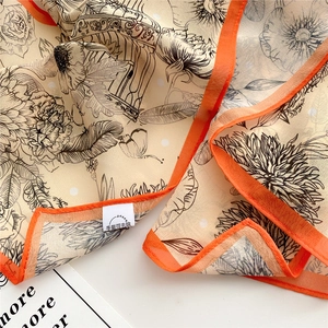 Detail of silk scarf showing vintage floral birdcage pattern and hand-rolled edges