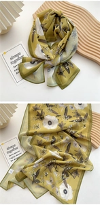 Detail of mustard yellow long silk scarf with white poppy flowers and butterfly prints