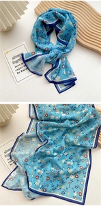 Detail of sky blue floral long scarf with high-quality stitching and chiffon texture
