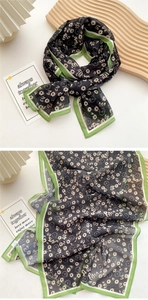 Detail of floral chiffon scarf with black background and green border styling