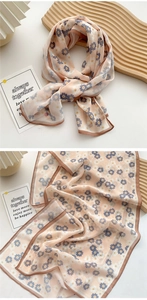 Detail of light pink floral chiffon scarf with delicate blue and white flower patterns
