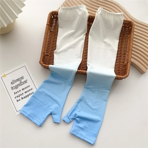 Detail of gradient blue sun sleeves with thumb holes and elastic cuffs on a tray