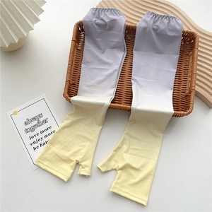 Detail of gradient ice silk sun protection sleeves with thumb holes on decorative tray
