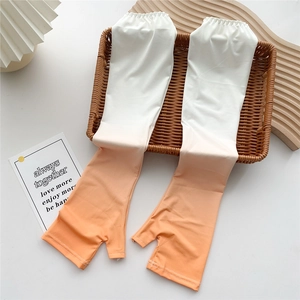 Detail of gradient ice silk sun sleeves with thumb holes in a warm summer setting
