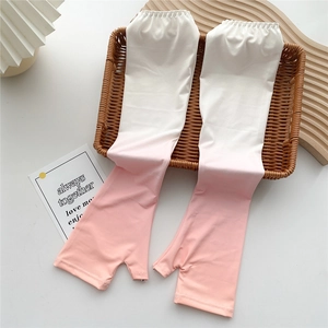 Detail of pink gradient sun sleeves with thumb hole and elastic cuff on a woven basket